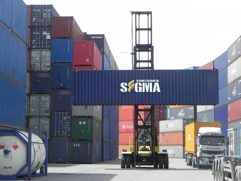 Reach stacker lifting a navy Sigma Container 40 foot unit
